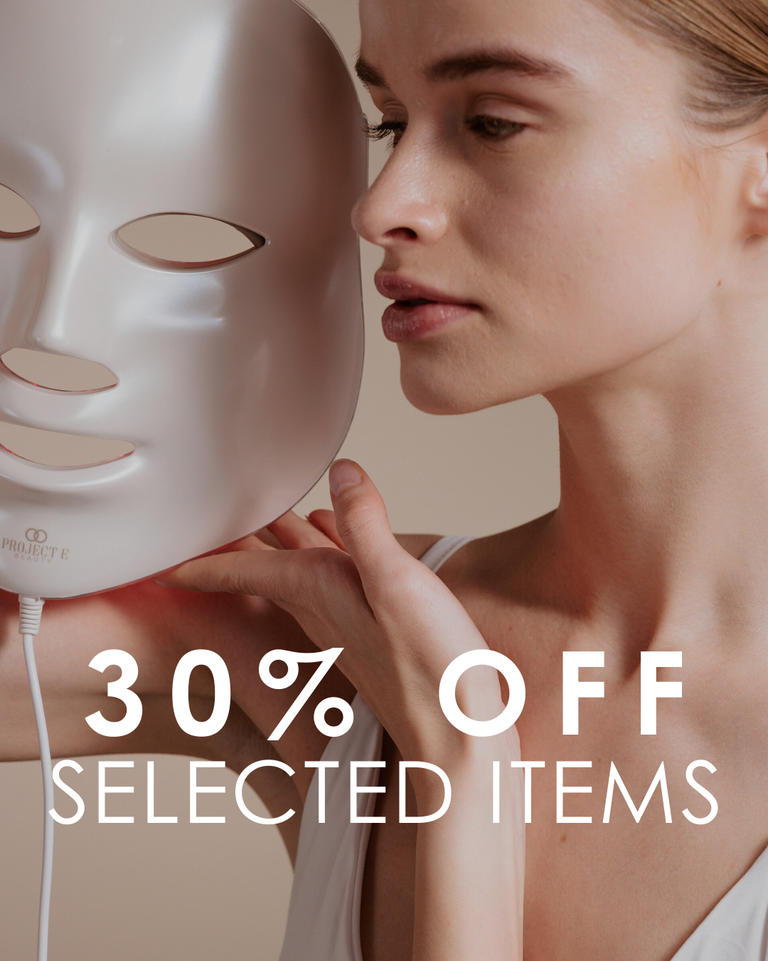 Woman targeting skin concerns with LED face mask